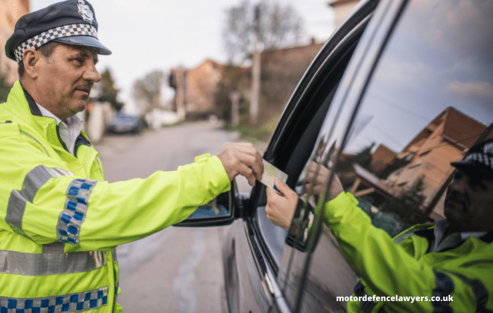 Driver handing police officer driving licence out of car window